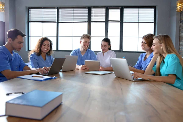 Group of smart medical students with gadgets in college