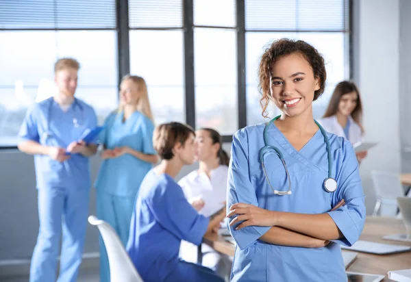 Smart medical student with her classmates in college — Stock Photo, Image