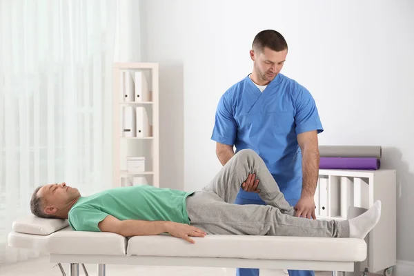 Doctor working with patient in hospital. Rehabilitation physiotherapy — Stock Photo, Image