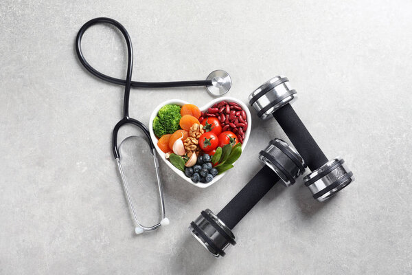 Flat lay composition with bowl of products for heart-healthy diet on grey background