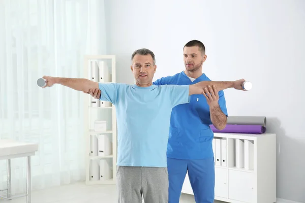 Doctor working with patient in hospital. Rehabilitation exercises — Stock Photo, Image