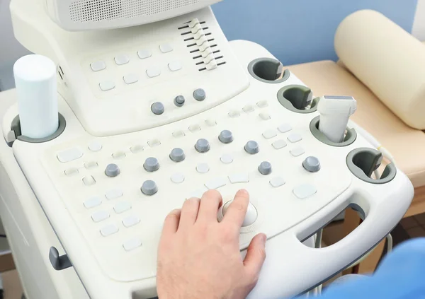 Sonographer operating modern ultrasound machine in clinic, closeup — Stock Photo, Image