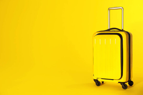 Stylish suitcase on color background. Space for text