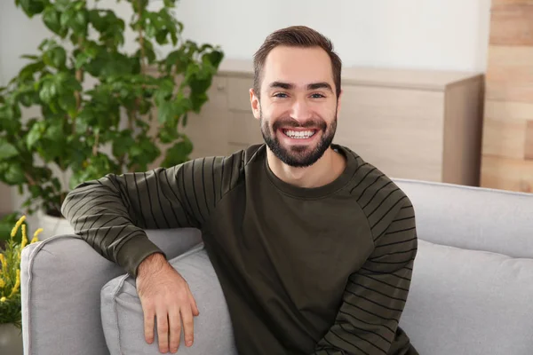 Portrait of young man laughing at home — Stock Photo, Image