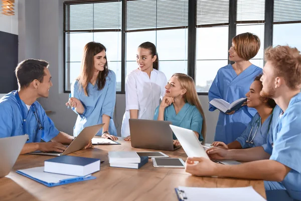 Group of smart medical students with gadgets in college