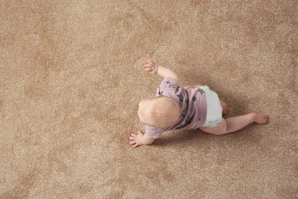 Cute little baby crawling on carpet indoors, top view with space for text — Stock Photo, Image