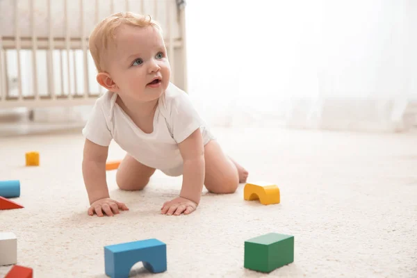 Cute little baby crawling on carpet indoors, space for text — Stock Photo, Image