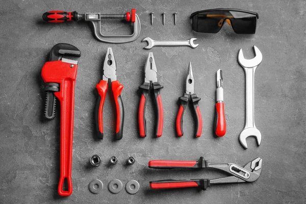 Flat lay composition with construction tools on grey background — Stock Photo, Image