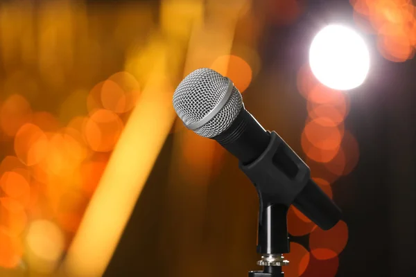 Microphone against festive lights, space for text. Musical equipment — Stock Photo, Image