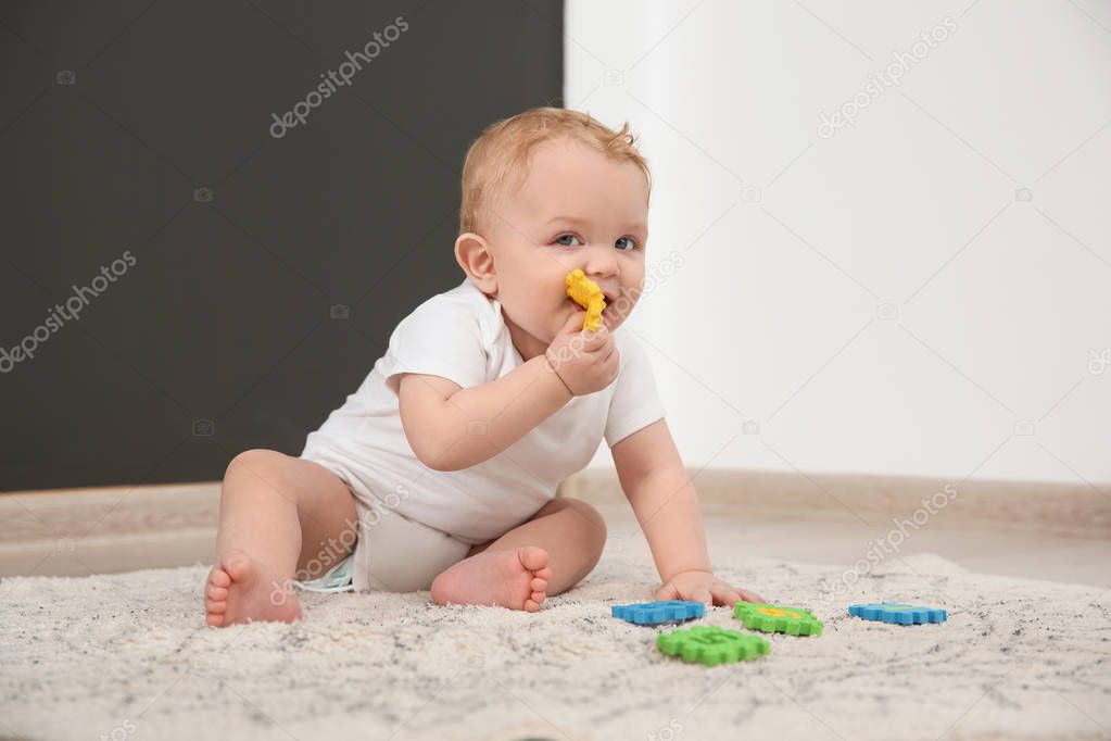 Cute little baby on rug indoors. Crawling time
