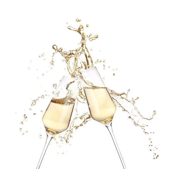 Glasses of champagne clinking together and splashing on white background — Stock Photo, Image