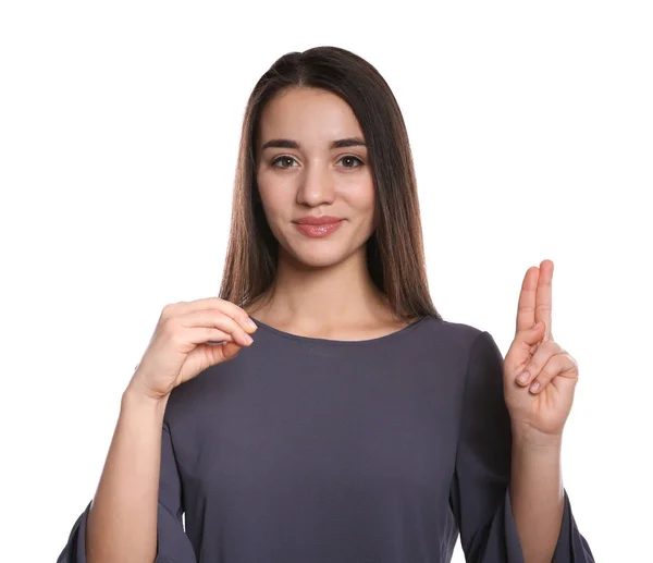 Mujer usando lenguaje de señas sobre fondo blanco — Foto de Stock