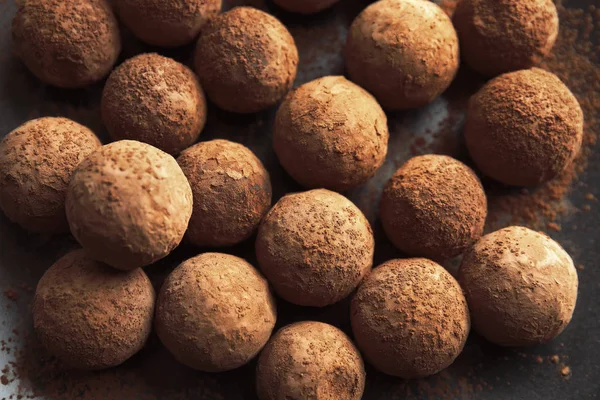 Tasty chocolate truffles on dark background, closeup — Stock Photo, Image