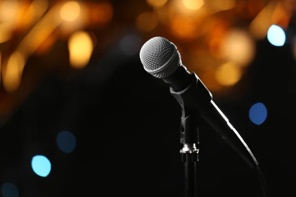 Microphone against festive lights, space for text. Musical equipment — Stock Photo, Image