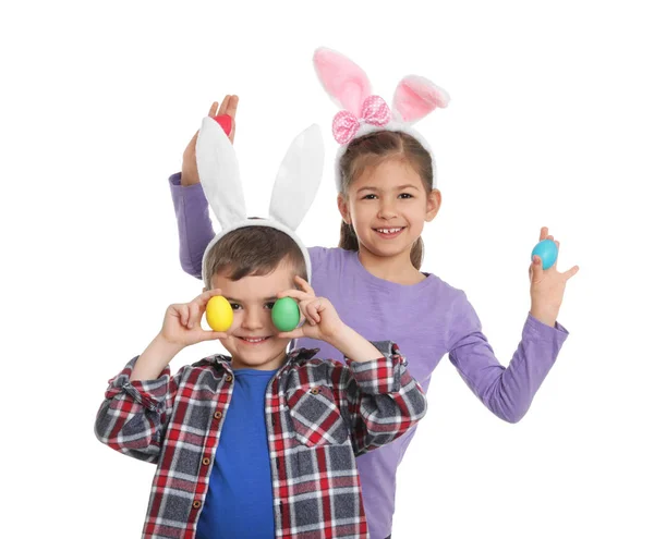 Niedlichen Kindern in Hasenohren Stirnbänder mit Ostereiern auf weißem Hintergrund — Stockfoto