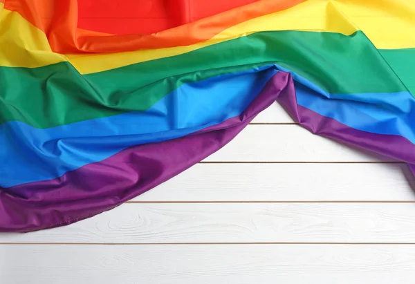 Bright rainbow gay flag on wooden background, top view with space for text. LGBT community — Stock Photo, Image