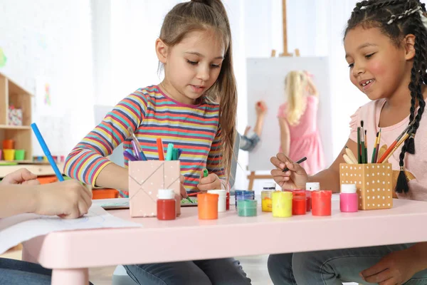 Cute little children drawing at painting lesson indoors — Stock Photo, Image