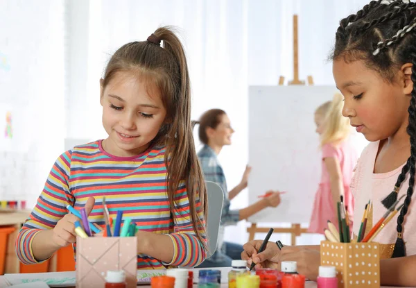 Cute little children drawing at painting lesson indoors — Stock Photo, Image