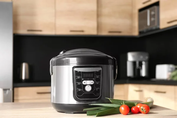 Modern multi cooker and ingredients on table in kitchen — Stock Photo, Image