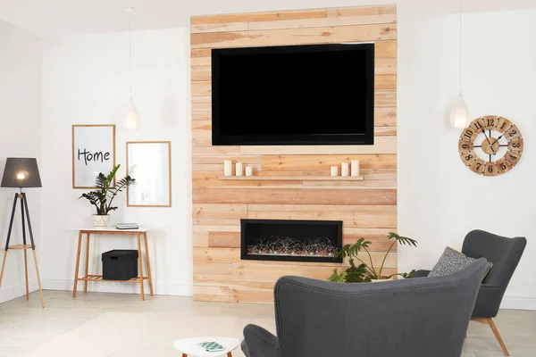 Living room interior with decorative fireplace in wooden wall — Stock Photo, Image