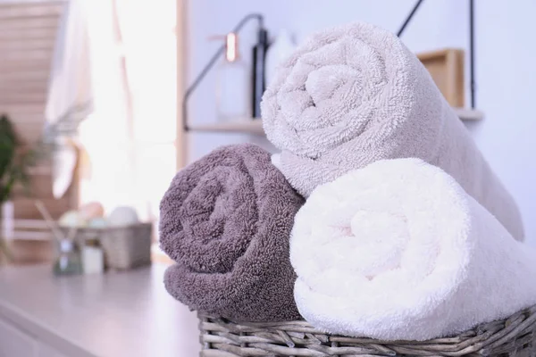 Basket with rolled fresh towels in bathroom, closeup. Space for text — Stock Photo, Image