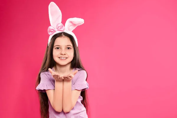 Portrait of little girl in Easter bunny ears headband on color background, space for text — Stock Photo, Image