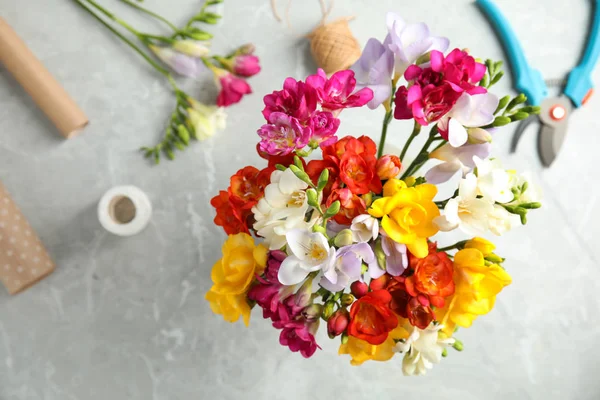 Flat lay composition with freesia bouquet on table — Stock Photo, Image