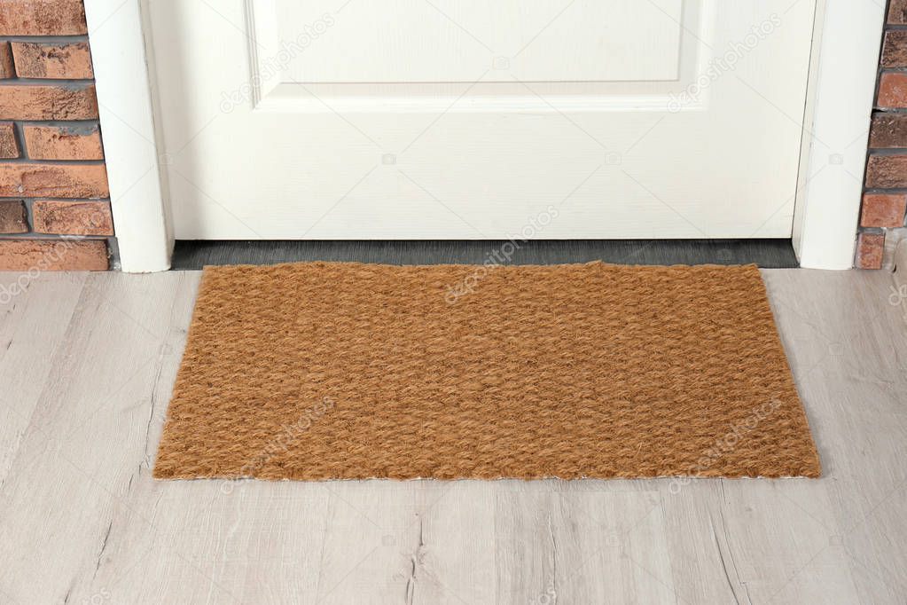 New clean mat near entrance door. Household item