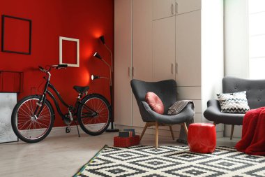 Modern living room interior with comfortable armchair, sofa and bicycle clipart