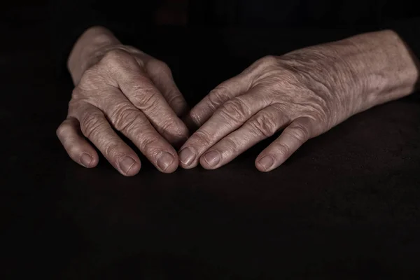 Poor mature woman at table, closeup of hands — Stock Photo, Image