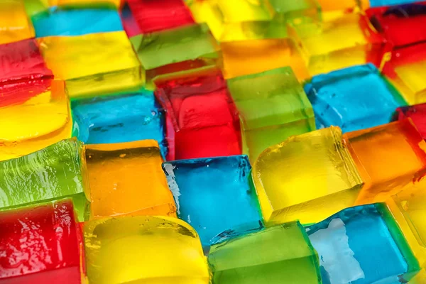 Sabrosos cubos de gelatina de colores como fondo, primer plano —  Fotos de Stock