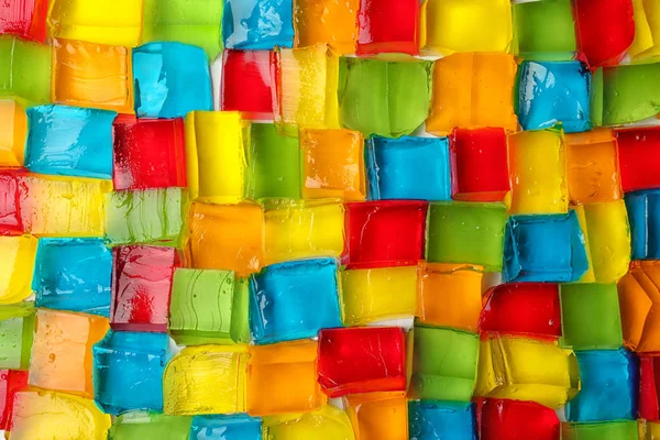 Tasty colorful jelly cubes as background, top view — Stock Photo, Image