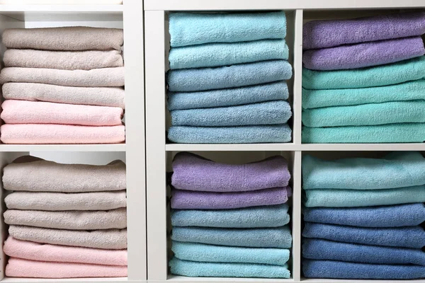 Colorful towels on shelves, closeup. Bathroom supplies — Stock Photo, Image