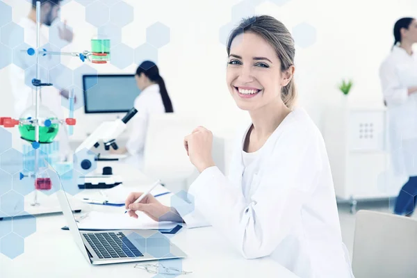 Medical student working with laptop in modern laboratory