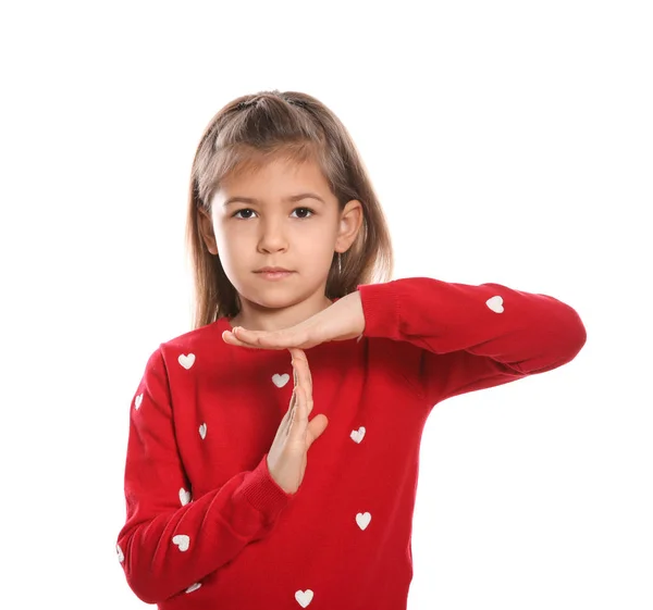 Маленька дівчинка показує жест TIME OUT на мові жестів на білому тлі — стокове фото