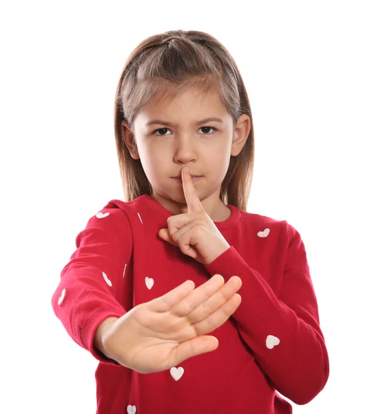 Маленька дівчинка показує жест HUSH на мові жестів на білому тлі — стокове фото
