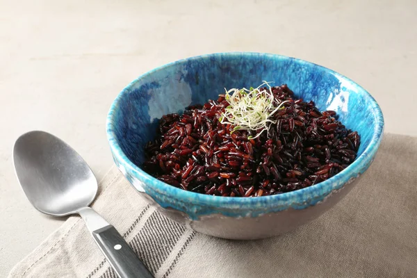 Cuenco de arroz integral hervido y cuchara en la mesa, primer plano — Foto de Stock