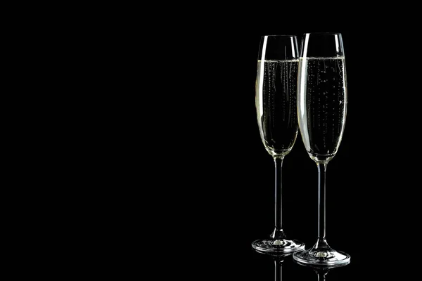 Glasses of champagne on black background, space for text — Stock Photo, Image