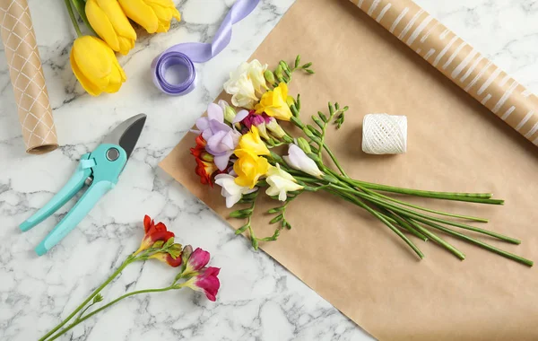 Flat lay composition with freesia flowers on table — Stock Photo, Image