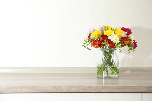 Beautiful spring freesia flowers in vase on table. Space for text — Stock Photo, Image