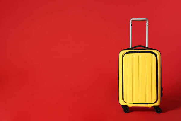 Stylish suitcase on color background. Space for text