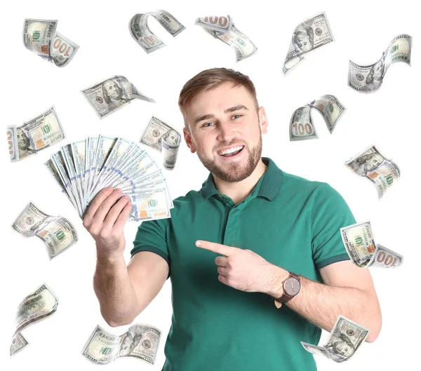 Retrato de un joven feliz con dinero y dólares estadounidenses volando sobre fondo blanco —  Fotos de Stock