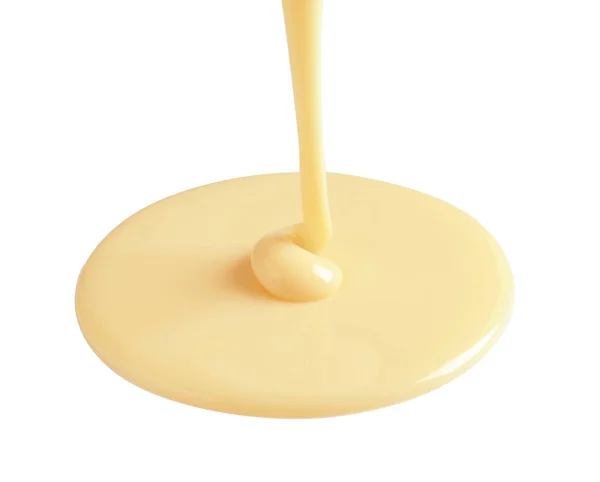 Tasty pouring condensed milk on white background. Dairy product — Stock Photo, Image