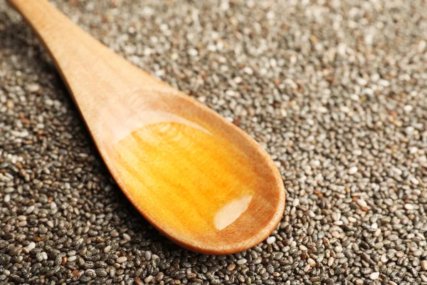 Spoon with chia oil on seeds, closeup. Space for text — Stock Photo, Image