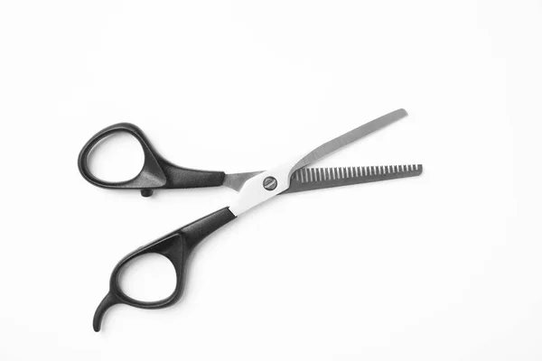 New thinning scissors on white background, top view. Professional hairdresser tool