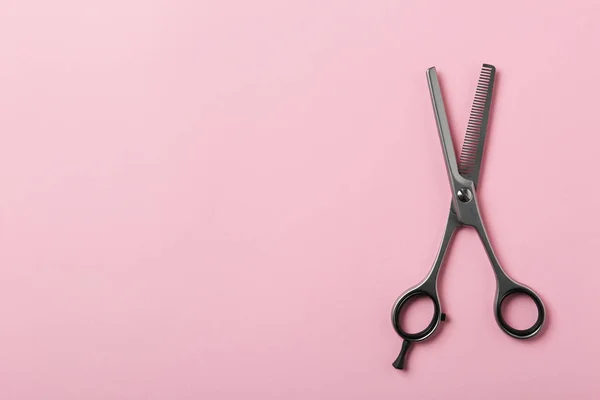 Thinning scissors and space for text on color background, top view. Hairdresser tool