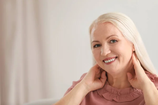 Portrait of beautiful older woman against blurred background with space for text — Stock Photo, Image