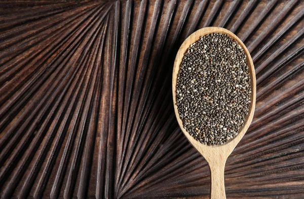 Spoon with chia seeds on wooden background, top view. Space for text — Stock Photo, Image