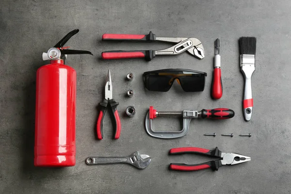 Flat lay composition with different construction tools on grey background — Stock Photo, Image