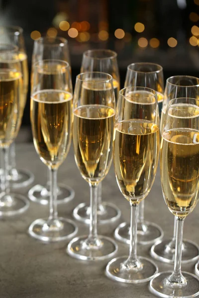 Glasses of champagne on table against blurred background — Stock Photo, Image